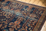 Antique Persian Mahal carpet detail: navy blue field, terra cotta florals, visible low pile.