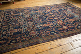 Antique Persian Mahal carpet, deep navy field, blossomed floral bouquets, and low, even pile.