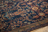 Detail of antique Persian Mahal rug's navy field with terra cotta and oxidized green flora.