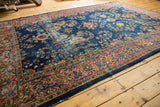 Intricate floral tendrils on a faded cobalt blue Mahal carpet field with terracotta border.