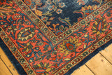 Vintage Mahal carpet corner featuring brick red border and dusty gold floral motifs.