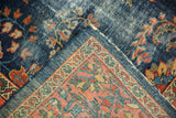 Mahal carpet folded corner detail, revealing cobalt blue floral pile and hand-knotted foundation.
