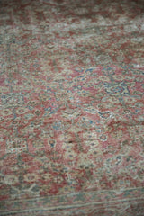 Distressed Mahal carpet's worn texture, exposed knot heads, and faded copper henna pattern.