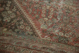 Hard wear and exposed foundation on a vintage Mahal rug with henna plant motif.
