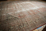 Corner of the distressed vintage Mahal carpet, showing worn pile and henna plant pattern.