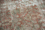 Aged texture of distressed Mahal carpet with wear exposing foundation, copper terracotta, ivory.