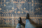 Distressed vintage Turkish Sparta carpet with royal blue, gold, and terracotta tendrils.
