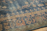 Textured wear on distressed Sparta carpet, showing faded royal blue field and terracotta patterns.