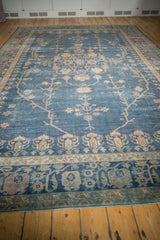 Distressed Sparta carpet border with worn royal blue field and faded floral patterns.