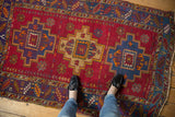 Low pile vintage Turkish rug with cherry red, blue geometric stepped medallions.