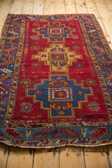 Rich royal blue-purple stepped medallion with tangerine on a cherry red field of germinating plants.