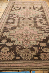 Distressed Karabagh runner pile with faded blush rose motifs, birds, and subtle foundation wear.