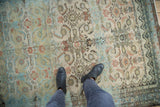 Distressed Hamadan rug texture, featuring muted Herati Mahi pattern with abrashes and low pile.