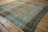 Secured light fringe and dark patterned border on a distressed Hamadan rug.
