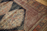 Sharply serrated navy medallion edge, madder red field, and detailed border of antique Afshar rug.