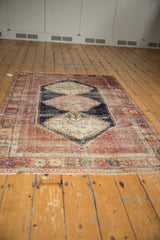 Bold antique Afshar rug with triple serrated medallions, navy field, and madder red borders.