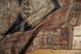 Sharply serrated navy stepped motif and madder red geometric border on this antique Afshar rug.