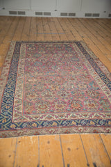Antique Malayer rug featuring an allover multi-panel floral design with plum, navy, and ivory hues.