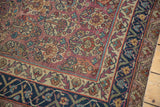 Antique Malayer rug corner: plum multi-panel floral field, dark navy border, low pile.