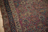 Antique Malayer rug border, dark navy stylized vines, and plum field's multi-panel floral motifs.