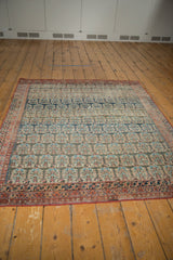 Antique Persian Heriz rug with navy, charcoal, blush boteh motifs, red border, mostly even wear.