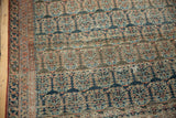 Antique Heriz rug's field and border detail with staggered boteh in muted blues and blush.