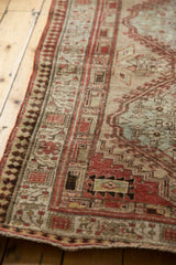 Distressed vintage Serab runner border with reciprocating pawn motif in terra cotta, sand, muted green.