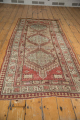 Secured end of vintage distressed Serab runner, with geometric pawn motif and low pile.