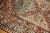 Distressed low pile Serab rug, serrated geometric patterns in sand, terra cotta, muted teal.