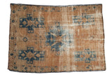 Distressed vintage Hamadan rug with sand, navy blue, and ivory, central floral medallion, 4'2