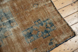 Distressed texture, exposed foundation, and secure side of a vintage Hamadan rug.