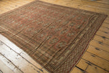 Distressed Afghan Bokhara carpet, geometric gul motifs, mostly even low pile, chestnut brown, muted silver.