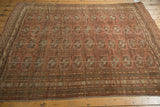 Distressed Afghan Bokhara rug detail with geometric elephant footprint guls and intricate striped borders.
