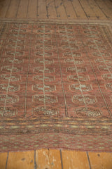 Distressed low pile geometric border in chestnut brown and muted silver.