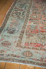 Vintage distressed Mehrivan carpet detail, rectilinear floral motifs, red terra cotta, slate blue, and low pile.
