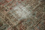 Distressed Mehrivan carpet detail with worn pile, revealing foundation in muted geometric patterns.