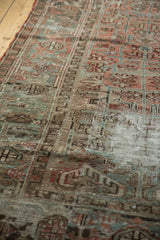 Distressed vintage Mehrivan carpet pile with worn geometric motifs and muted colors.
