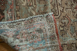 Distressed Vintage Mehrivan Carpet's worn pile and hand-knotted foundation in muted blue, red, and beige.