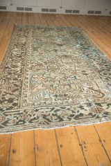 Distressed Mehrivan runner's secured fringe and faded geometric patterns in ivory, blue, brown.