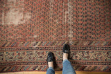 Distressed vintage Malayer runner showing worn madder red field with Mir Boteh motif and detailed borders.