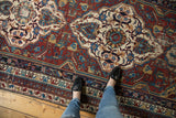 Antique Shirvan carpet with bold geometric medallion in wine red, sky blue, and ivory tones.
