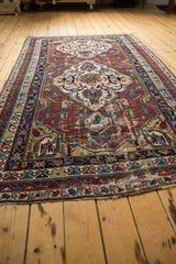 Antique Shirvan carpet's geometric medallion in wine red, sky blue, ivory, with visible historic wear.