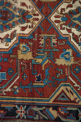 Visible knotting and worn geometric tribal patterns of the antique Shirvan rug.