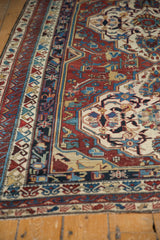 Section of antique Shirvan carpet, wine red geometric medallion, multiple borders, and patinated pile.