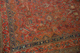 Vintage Qashqai rug corner showing intricate geometric flora in cherry red and navy blue.