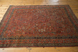 Lower border of vintage Qashqai rug featuring intricate geometric motifs in navy and red.