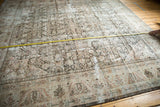Faded Herati pattern, visible wear, and measuring tape on a distressed Mahal carpet.