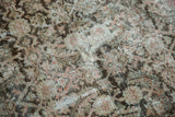 Close-up texture of vintage distressed Mahal rug with worn Herati design in soft blush and beige.