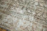 Distressed Mahal carpet, faded Herati motif, visible seam in ivory, blush, charcoal.