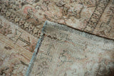 Distressed Mahal carpet's folded corner reveals muted Herati pattern and restrung hand-knotted foundation.